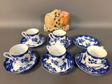 a group of blue and white china cups and saucers