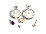 three different types of pocket watches on a white surface
