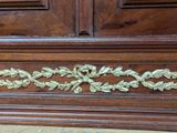 an image of a wooden cabinet with a gold leaf decoration