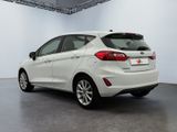 the rear end of a white ford fiesta parked in a showroom