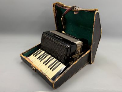 an old accordion sitting in a suitcase on a table