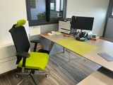 a desk with a chair and a computer on it