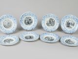 six blue and white plates with images of people on them