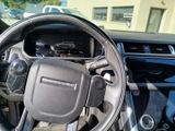 a steering wheel of a car that is parked in a lot