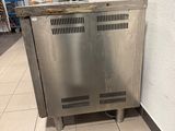 a metal cabinet in the middle of a tiled floor