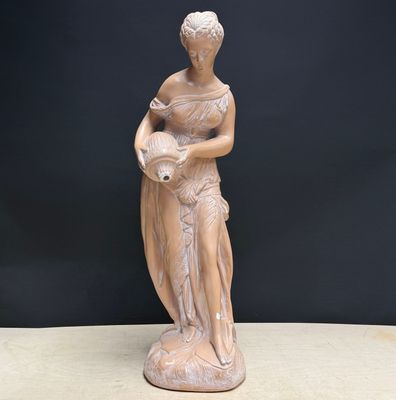 statue of a woman holding a vase on a table