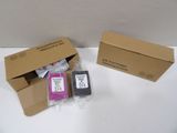 two ink cartridges in a cardboard box next to a box of other ink