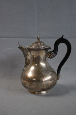 an antique silver coffee pot with a black handle on a white background