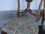 two chairs sitting next to each other on a carpet