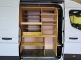 a white van with a wooden shelf in the back