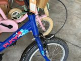 a small child ' s bike with a basket on the back of it