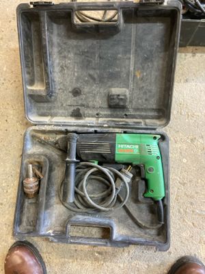 a person standing next to a tool in a case