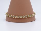 un gros plan d'un bracelet en or et diamants sur un mannequin