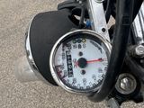 a close up of a motorcycle with a speedometer on it ' s handlebar