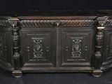 un buffet de style ancien orné de sculptures raffinées sur les côtés