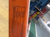 a close up of an orange fire hydrant on a table