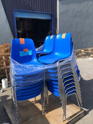 a lot of blue chairs sitting on a pallet