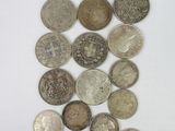 several different types of coins are arranged on a white surface