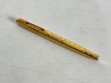 a close up of a pen laying on a white surface