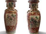 pair of chinese vases with asian scenes on them against a white background