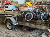 a truck with a trailer full of toys and a car