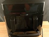 an image of a black toaster on a wooden table