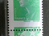 two stamps with a woman ' s face on them on a table