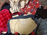 a suitcase full of clothes that is sitting on the floor