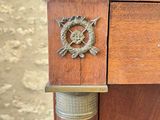 a close up of a wooden desk with a clock on top of it