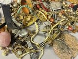 a pile of assorted jewelry on a table