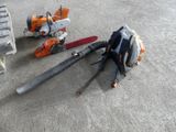 two chainsaws that are laying on the ground