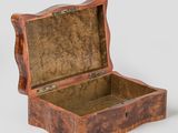 an old wooden box sitting on top of a white surface