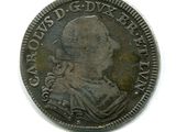 une vieille pièce de monnaie sur laquelle figure l'effigie d'un homme, sur un fond blanc