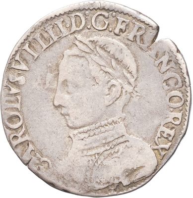 gros plan d'une pièce de monnaie sur laquelle figure une tête de femme