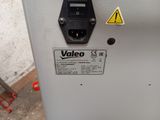 a close up of a machine with a yellow warning sign on it