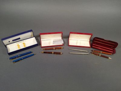 three pens and a pen in a case on a table