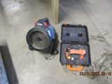 a blower and a tool in a case on the floor