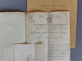 Plusieurs vieilles lettres et documents sont posés sur une surface bleue