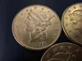 three quarters of the same type of coin are shown on a blue surface