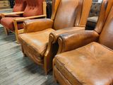 leather recliners are lined up in a large room with wood floors