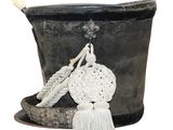 a black bucket with a rope and a wooden handle
