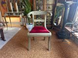 a chair with a red seat in a room