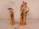 two fire extinguisors sitting next to each other on a table