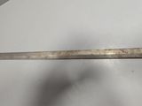 a close up of a knife on a table with a white background