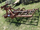an image of a tractor plow in the grass