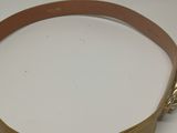 beige leather belt with a metal buckle on a white surface