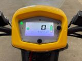a yellow motorcycle with a digital display on the back of it