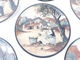 many plates with pictures of people on them on the wall