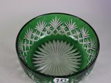 a green glass bowl with a flower design on it