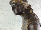 a statue of a woman with a basket on her lap